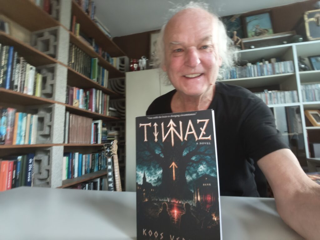 Author Koos Verkaik holding a copy of his new novel, Tiwaz